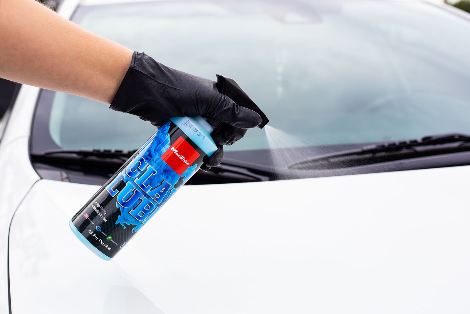 Clay Lube Spray onto White Car Hood